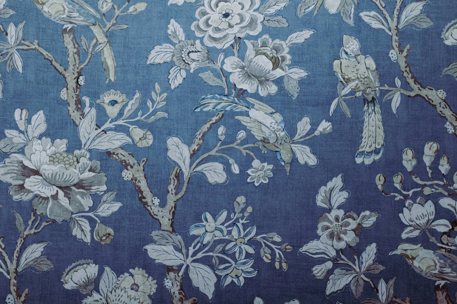 After: the photograph colour graded — a deep blue ground with the cream florals and birds lifted off it